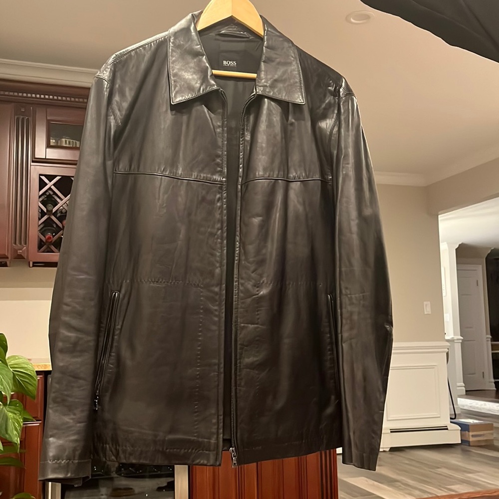 This is a black, mens leather jacket from yugo boss.